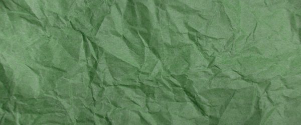 Wrinkled green paper textured background.
