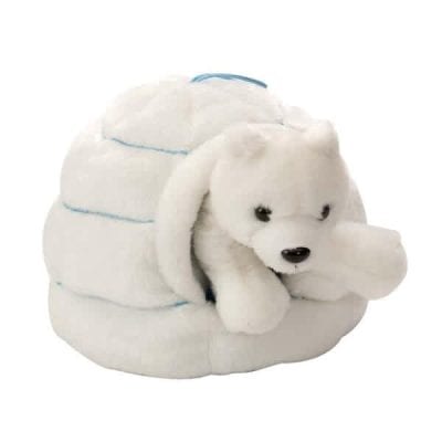 A stuffed polar bear sitting in a small igloo.