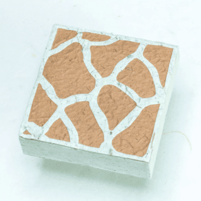 Image of paper scratch pad made out of poo with giraffe print on the front