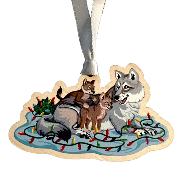 Image of an ornament of a grey wolf with two pups on top of a string of lights
