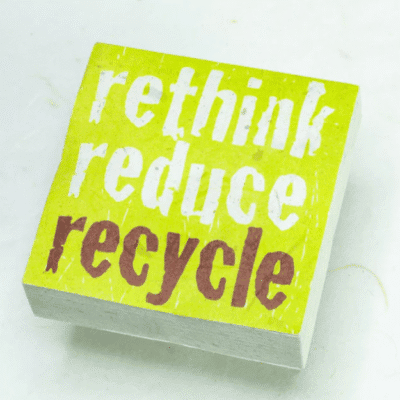Image of paper scratch pad made out of poo with rethink reduce recycle written on the front