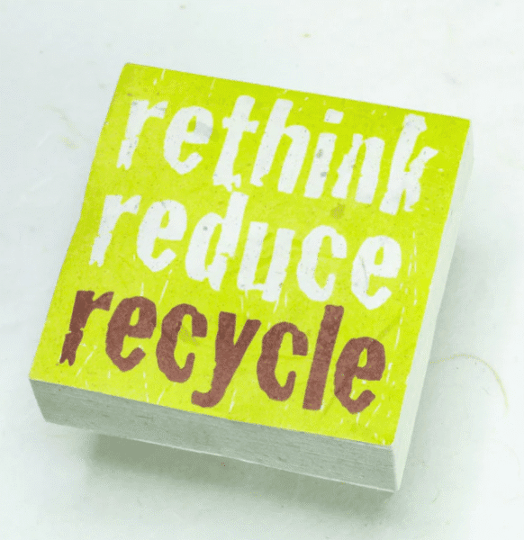 Image of paper scratch pad made out of poo with rethink reduce recycle written on the front