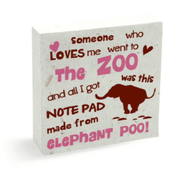 Image of a elephant poo paper scratch pad, with the words "someone who loves me went to the zoo and all I got was this notepad made from elephant poo" in pink