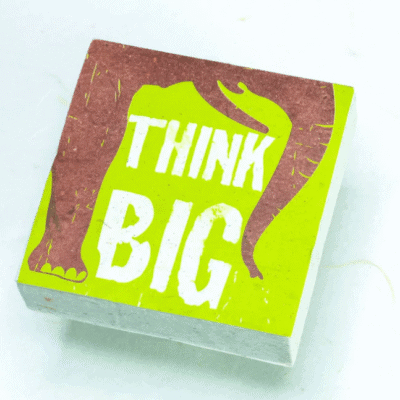 Image of paper scratch pad made out of poo with think big written on the front