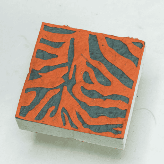 Image of paper scratch pad made out of poo with Tiger print on the front