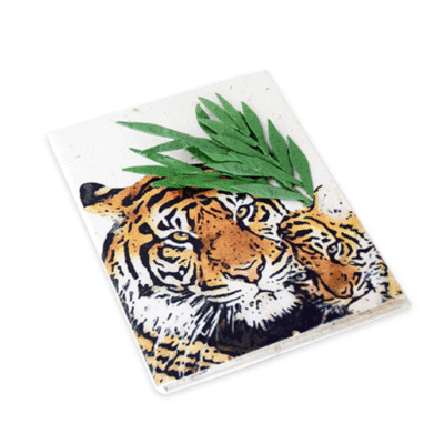 Image of a small journal made out of poo with a mom and baby tiger on the cover