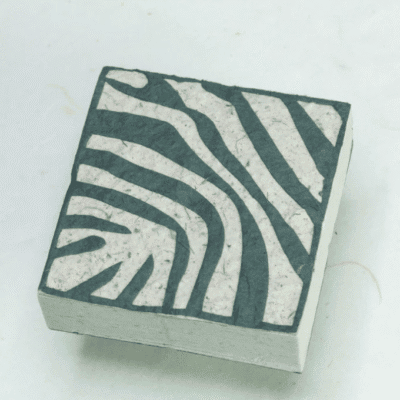 Image of paper scratch pad made out of poo with Zebra print on the front