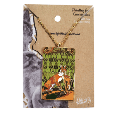 Image of artistic swift fox enamel pendant in orange and green.