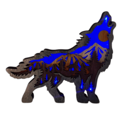 Image of wooden howling wolf ornament with laser cut layers showing a mountain forest scence